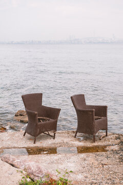 Wicker chairs overlook the sea and creates serene scenery