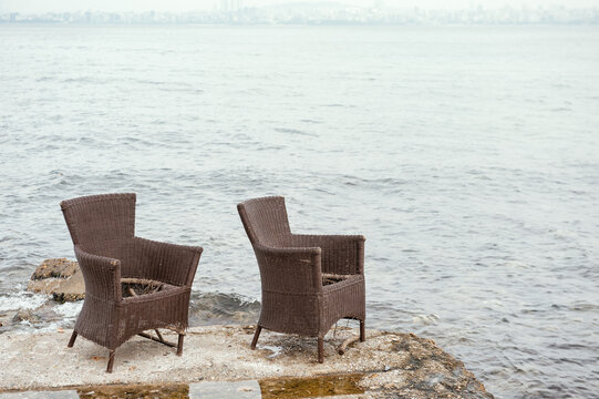Wicker chairs overlook the sea and creates serene scenery