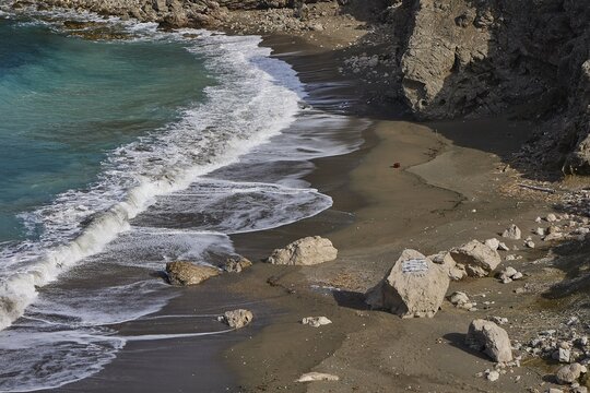 Waves running over a rocky beach shore with sand and water, Atavyros beach, near Monolithos village, Rhodes, Dodecanese, Greek Islands, Greece