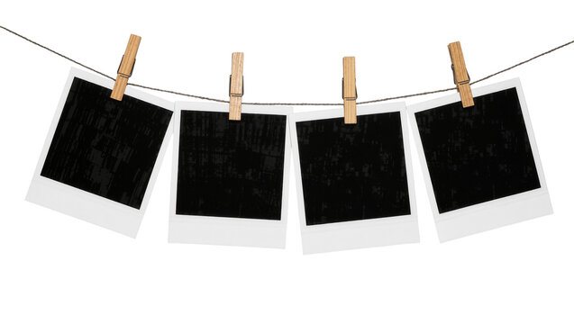 Four blank instant film photos clipped to a clothesline, isolated on transparent background