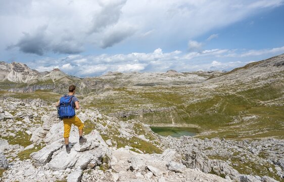 Hikers on the circular trail around the Sella Group near Lake Lech de Crespeina, Lake Crespeina, Gardena Pass, Passo Gardena, nature park Park Puez-Geisler, Dolomites, Selva di Val Gardena, South Tyrol, Trentino-Alto Adige, Italy