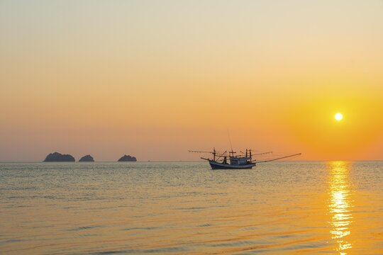 Boat in the sea at sunset in front of small islands, Koh Samui, Gulf of Thailand, Thailand