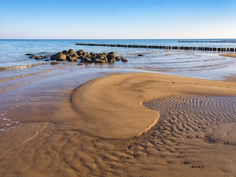 Pristine beach on the Baltic Sea with groynes, sandbank, boulders and sand ripples, Baltic resort K&uuml;hlungsborn, Mecklenburg-Western Pomerania, Germany