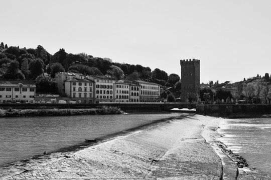 Black and white view of San Niccolo tower and weir on Arno river, Florence, Tuscany, Italy
