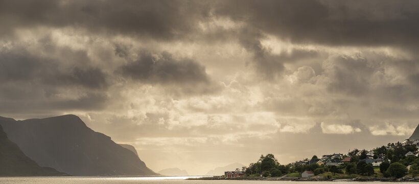 Dramatic lighting and dark clouds over the sea, islands, near &Aring;lesund or Alesund, M&oslash;re og Romsdal county, Norway