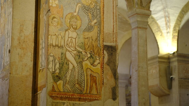 Fresco of the Baptism of Christ in the crypt of San Fermo Maggiore Church, Verona, Italy. Medieval mural painting details.