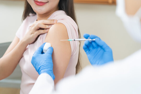 Health care, corona virus, hand of woman nurse, doctor giving syringe vaccine, injection dose on arm sick patient at clinic. Vaccination, immunization disease prevention against flu pandemic influenza