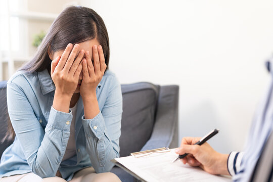 Psychology, depression. Burnout asian woman consultation with psychologist while patient counseling mental therapy, doctor hand taking notes at clinic. Psychologist with sick mental health people.