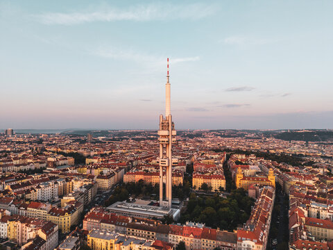 Aerial view of Zizkov Television Tower rising above the historic rooftops and urban landscape of Prague, Prague, Czechia.