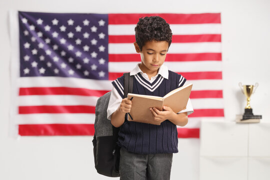 Boy in a school uniform reading a book
