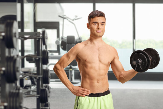 Muscular man doing a bicep curl with a dumbbell