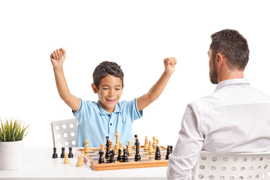 Boy winning a chess game against his father