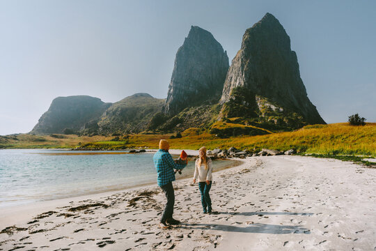 Mom dad and baby spending holidays together on beach in Norway, family travel lifestyle parents and child explore Helgeland islands bonding love outdoor vacations candid emotions happy moments