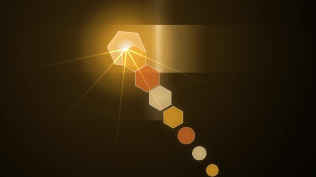 Golden glowing lens flare animation featuring bright sunburst light effects and geometric hexagonal bokeh elements video footage