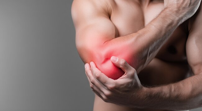 Man holding his painful elbow with visible redness indicating injury or inflammation
