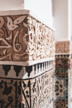 View of intricate ornamental plaster work found in Madrasa Ben Youssef located in Marrakesh, Morocco. The designs showcase skilled craftsmanship and cultural heritage.