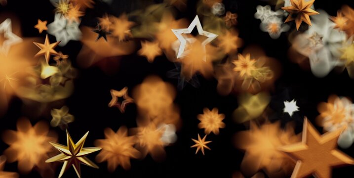 A festive and magical abstract background featuring sparkling golden stars and soft bokeh lights.
