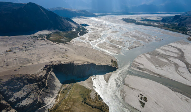Aerial view of the Indus River flowing through the sandy landscape of Skardu, Gilgit, Pakistan.