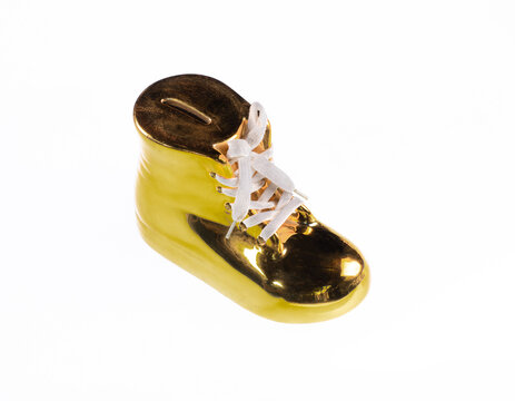 Gold shoe piggy bank isolated on a white background.