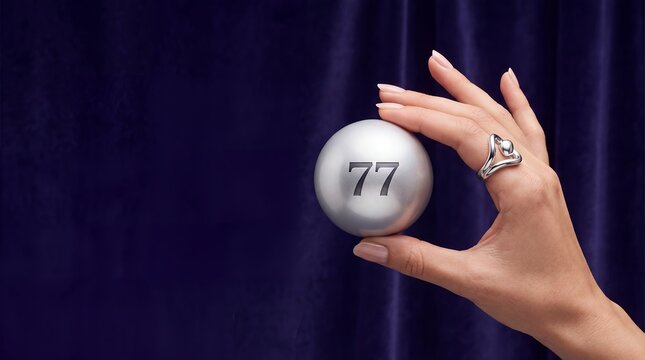 Lottery ball silver numbers hand holding velvet purple elegant luxury ideal for lottery advertising casino promotions jewelry websites digital screens and premium prize draw banner campaigns