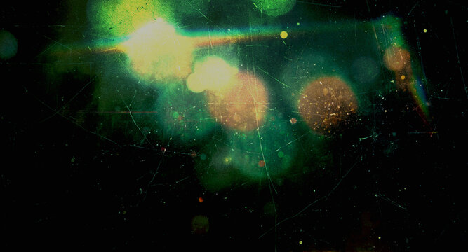 vintage light leak with glowing green and yellow bokeh, orange circles, rainbow light streaks, heavy scratches, dust particles and film grain texture on a black background for overlays and designs