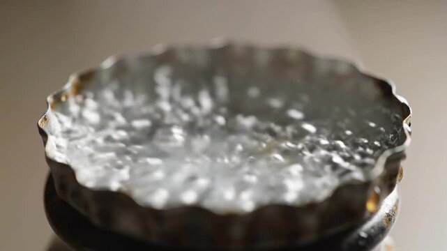 Boiling water bubbling intensely inside vintage metallic container during cooking process in kitchen macro video footage