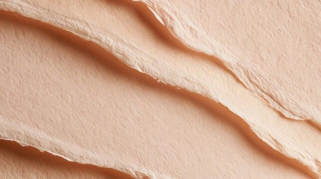 Close-up of a piece of peach-colored fabric with a textured surface. the fabric appears to be made of a soft, silky material and has a smooth, velvety texture.