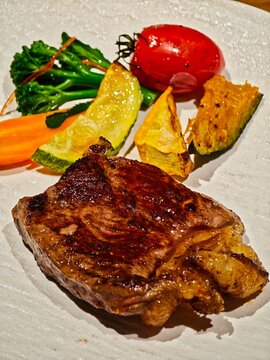 Seared steak with roasted pumpkin, zucchini, and vegetables