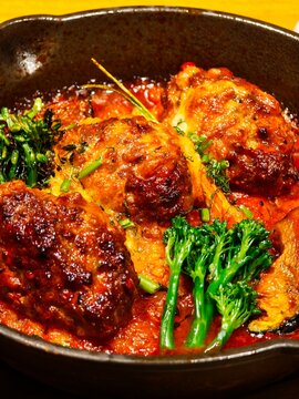 Glazed rustic meatballs with broccolini in rich tomato sauce