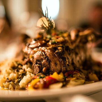 Roasted meat dish served with herbs and sauteed vegetables cooked meat savory dish