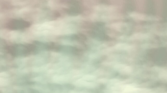 Abstract ethereal light beams shining through soft hazy clouds