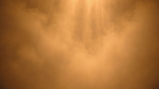 Divine light rays shining through ethereal golden clouds in a dramatic sky. Spiritual heavenly background with sunbeam effect