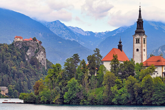 Church of the Assumption of Mary on Bled Island and Bled Castle against Julian Alps, Slovenia