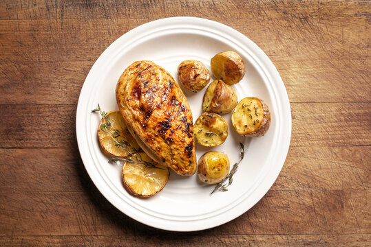 Oven roasted lemon garlic chicken and potatoes on plate