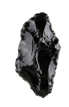 Handcrafted obsidian stone tool with sharp conchoidal fracture edges on a white background