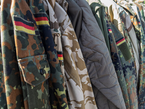 Military Uniforms Display: Various Camouflage Patterns and Styles