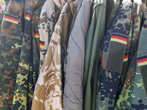 Variety of Military Camouflage Jackets Displayed Outdoors