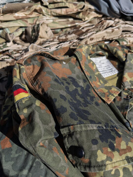 German Military Camouflage Uniform Close-Up on Fabric Stack