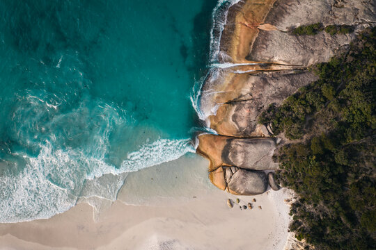 Aerial view of Two Peoples Bay Nature Reserve featuring turquoise water, white sand beach, and rocky coastline in Albany, Western Australia, Australia.