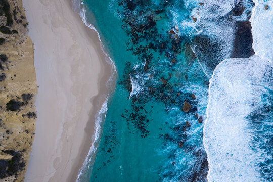 Aerial view of Two Peoples Bay Nature Reserve featuring turquoise ocean waters, white sand beach, and rocky coastline in Albany, Western Australia, Australia.