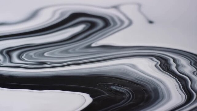 Black and white liquid marble patterns flow and swirl smoothly across a white surface. Animated scene combines fluid waves and marble-like layers with smooth blending.
