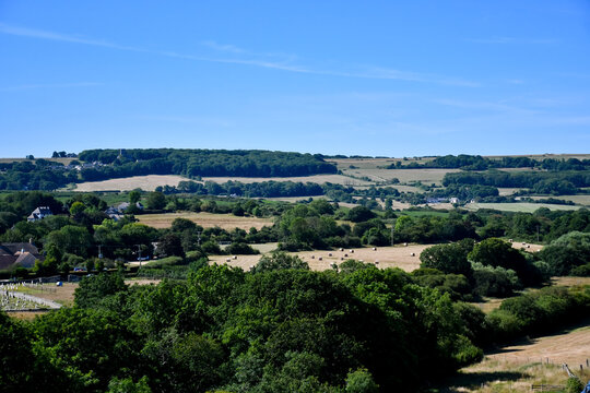 Our green and pleasant land? Views over English landscape on a summers day as climate change leads to dry arid conditions and burnt out countryside as fields are brown and dried out.