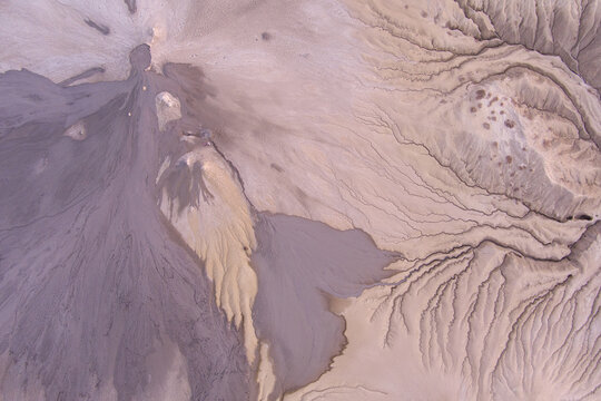 Aerial view of the mud volcanoes at Vulcanii Noroiosi Paclele Mari showing intricate patterns of dried mud flows and geological formations in Paclele, Buzau County, Romania.