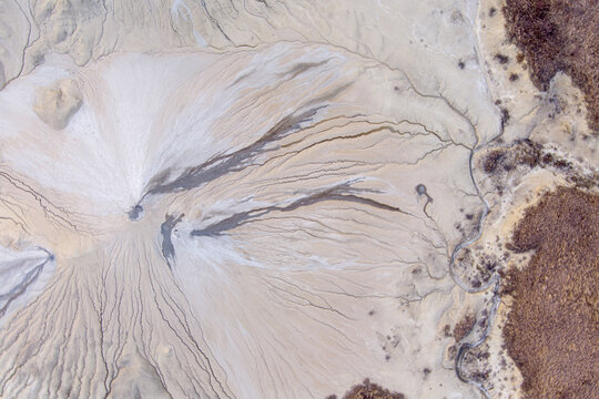 Aerial view of the mud volcanoes at Vulcanii Noroiosi Paclele Mari, showing intricate patterns of dried mud flows and volcanic craters in Paclele, Buzau County, Romania.