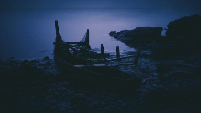Foreground wreck closeup at twilight shore, upclose timbers and splintered posts sit on textured pebble field, calm sea backdrop, cinematic lowlight, somber