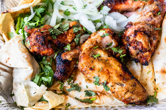 grilled chicken wings close-up with sliced onion