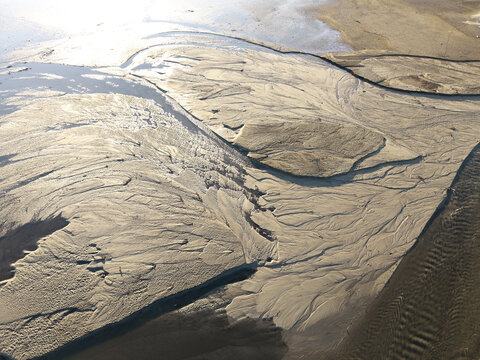 Aerial view of Lake Czorsztynskie with intricate sand patterns and sediment deposits along the shoreline, Nowy Targ County, Lesser Poland Voivode, Poland.