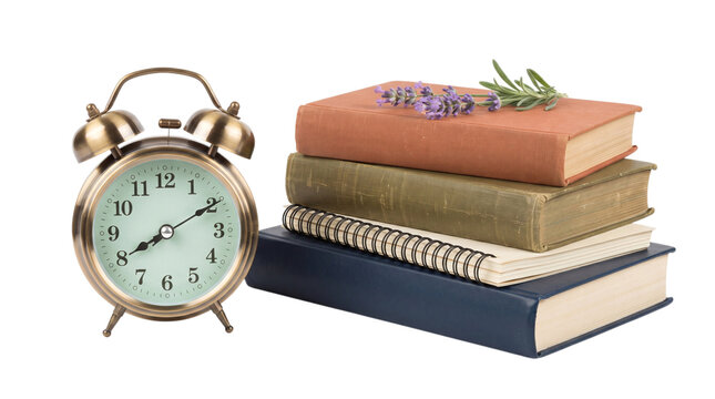 Vintage alarm clock with stack of books and lavender for study or office decor inspiration.
