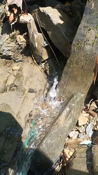 Natural Waterfall Flowing Through Rocky Mountain Terrain Outdoor Scene