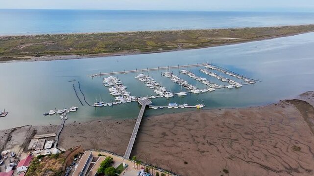Aerial video of the marina, the Piedras River, the La Flecha de El Rompido Natural Area, and the Atlantic Ocean. Andalusia